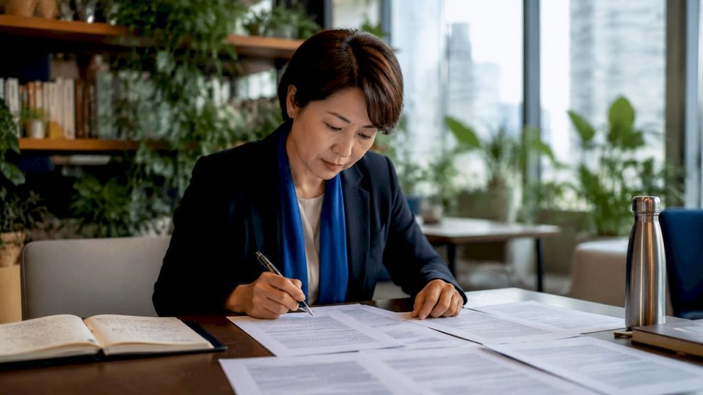 Businesswoman reviewing bilingual contract documents