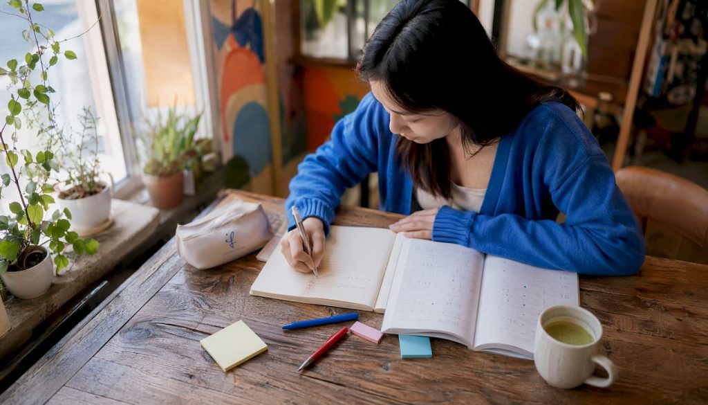 Woman studying advanced Japanese language at desk