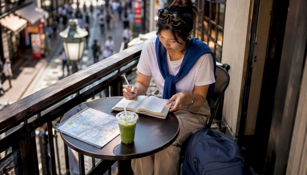 Traveler studying Japanese phrasebook at café