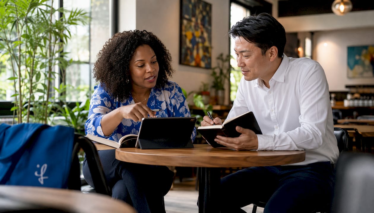 Two professionals discussing language skills in co-working space