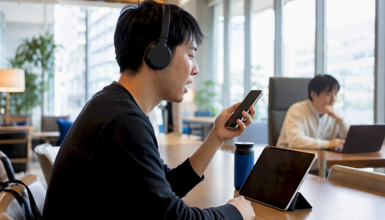 Person shadowing Japanese audio with headphones