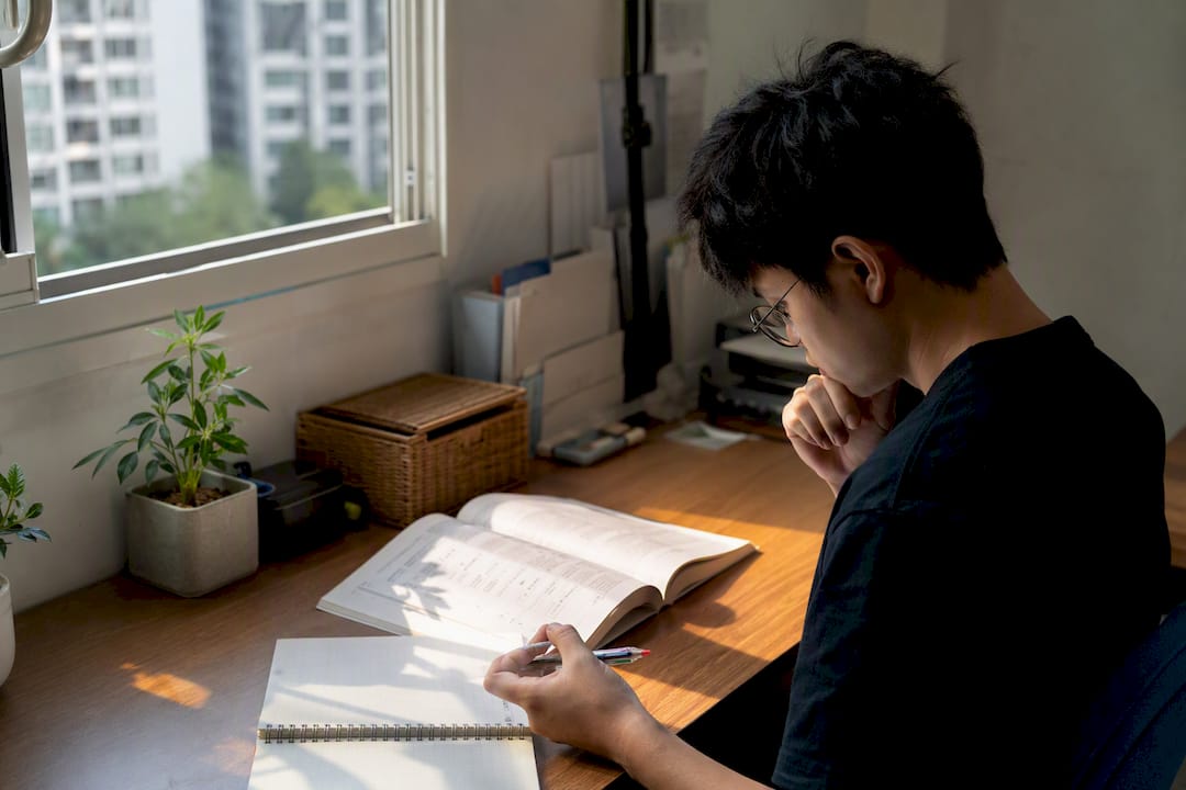 Study desk with Japanese grammar book and pen
