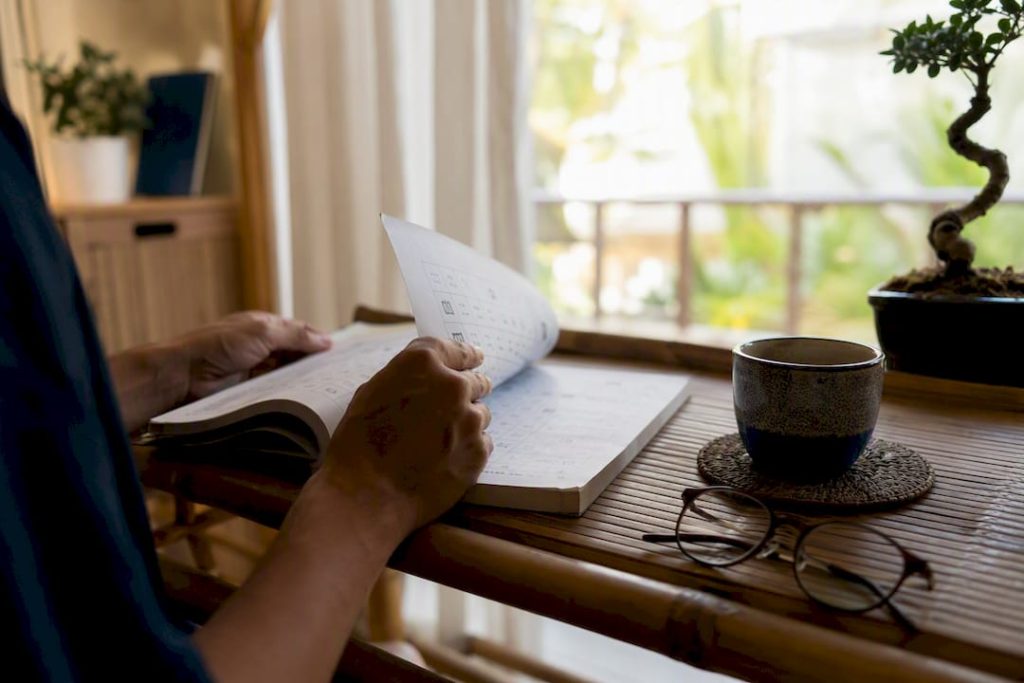 Adult hands arranging Japanese study materials