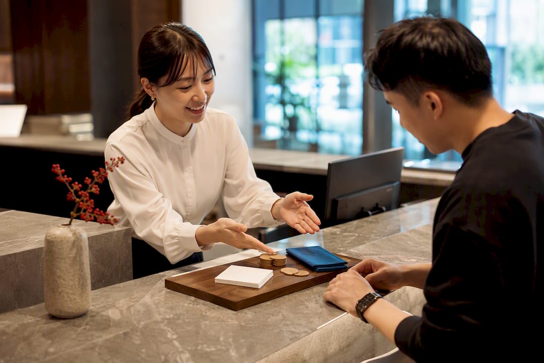 Learner reviewing JLPT course fees with adviser