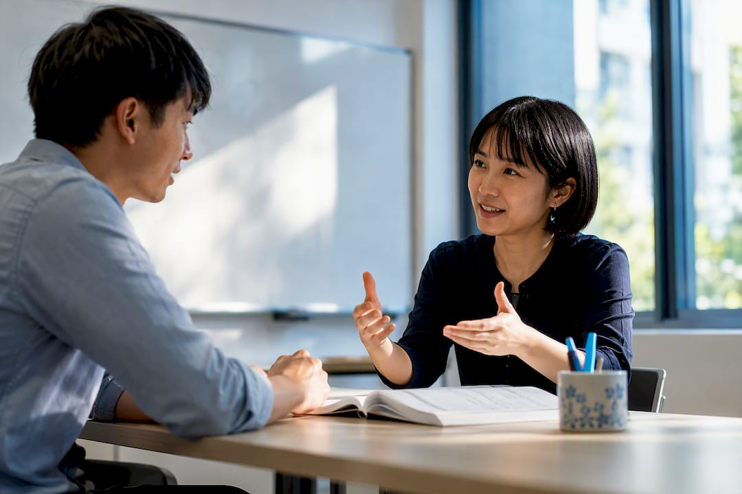 Adult learners practising Japanese conversation in class